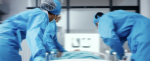 Hospital emergency room with stretcher A hospital emergency ward with medical staff attending to a patient